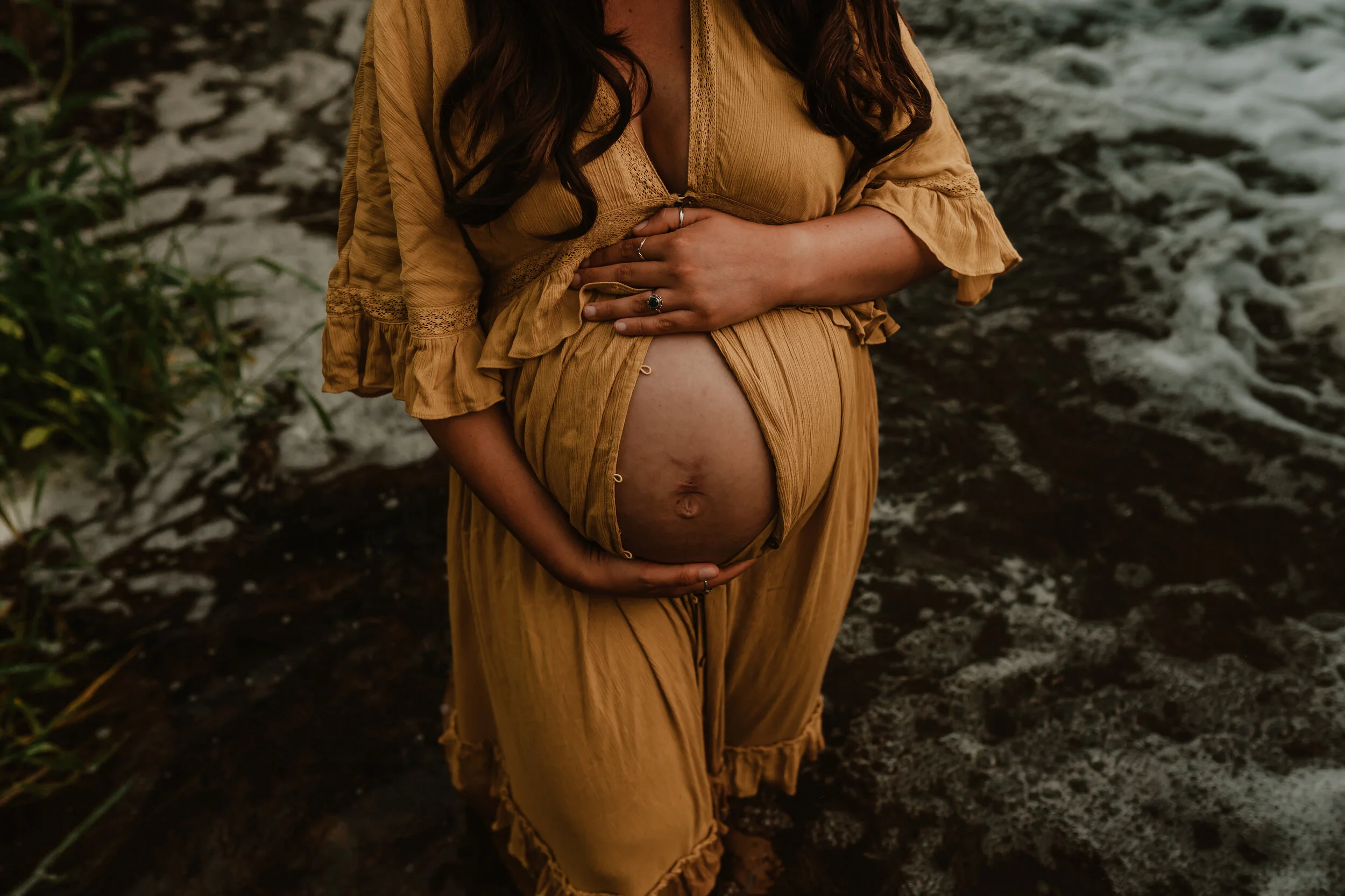 A pregnant woman standing in water